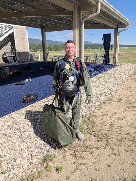 A Det 009 cadet with his parachuting equipment at Freefal Parachute Training