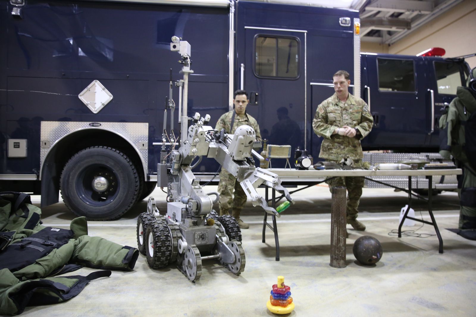 An EOD technician operates a bomb disposal robot